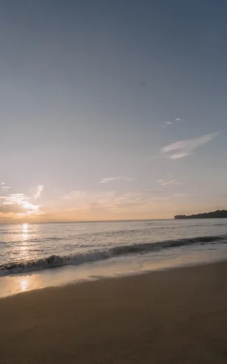 a tranquil sunrise over a sri lankan beach with soft waves. a tranquil sunrise over a sri lankan beach with soft waves.